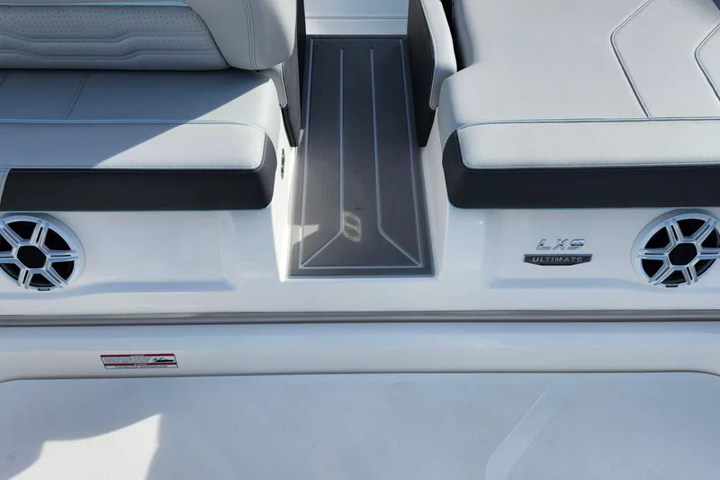 Slide: The Image of 2026 Regal LX9 boat interior with sleek seating and speaker system. - 43