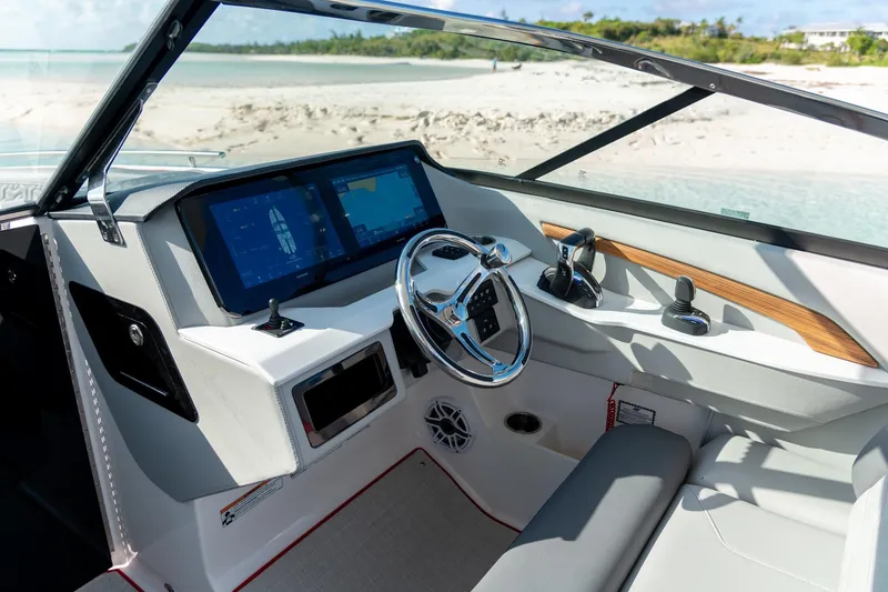 Slide: The Image of 2026 Regal LX9 boat storage compartment with speaker and cup holders. - 7