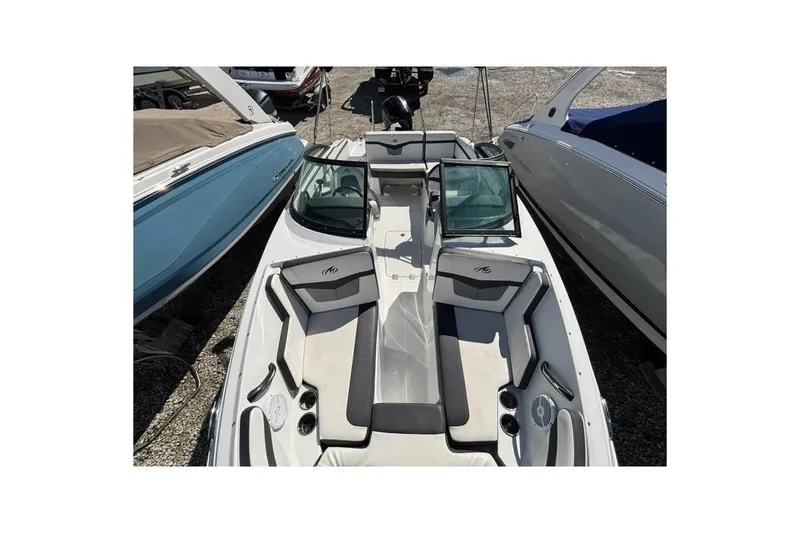 Slide: The Image of 2019 Monterey M-205 boat interior with seating and windshield, docked between other boats. - 11