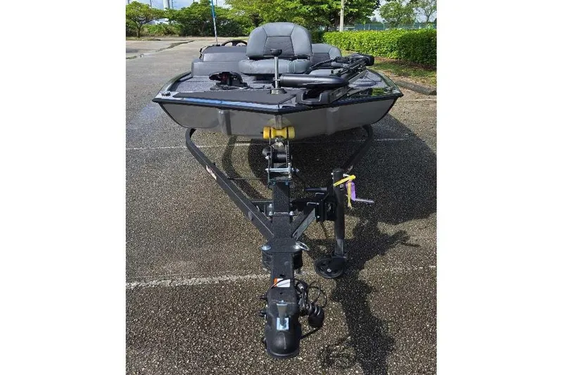 Slide: The Image of 2026 Tracker Bass Tracker Classic XL boat on trailer in parking lot. - 2