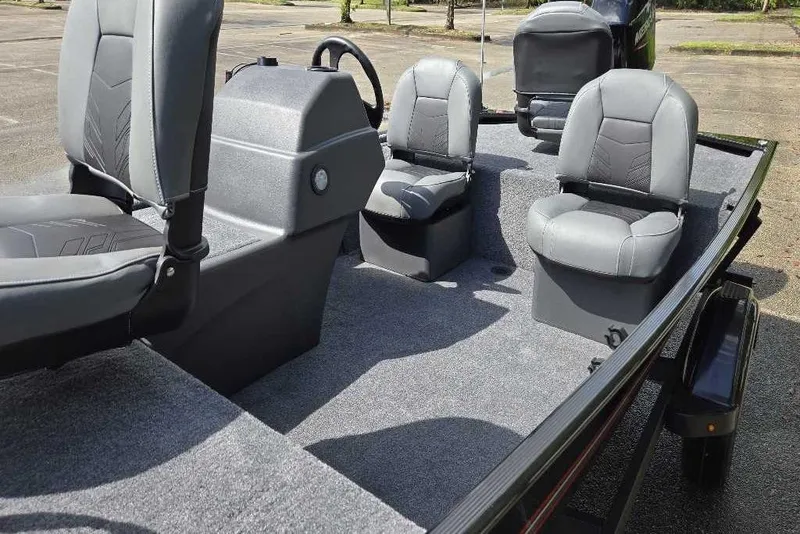 Slide: The Image of 2026 Tracker Bass Tracker Classic XL boat interior with gray seating and steering console. - 3