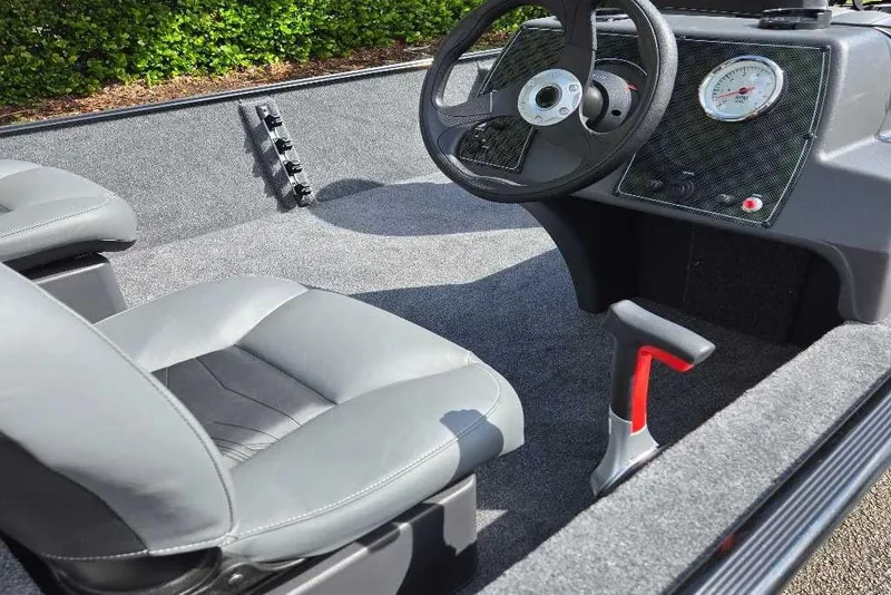 Slide: The Image of 2026 Tracker Bass Tracker Classic XL boat interior with steering wheel and seating. - 4