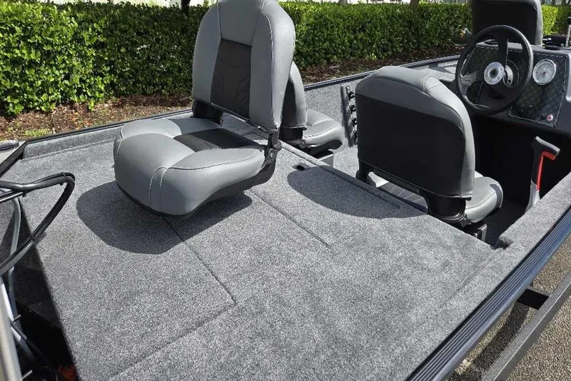 Slide: The Image of 2026 Tracker Bass Tracker Classic XL boat interior with gray seating and steering console. - 5