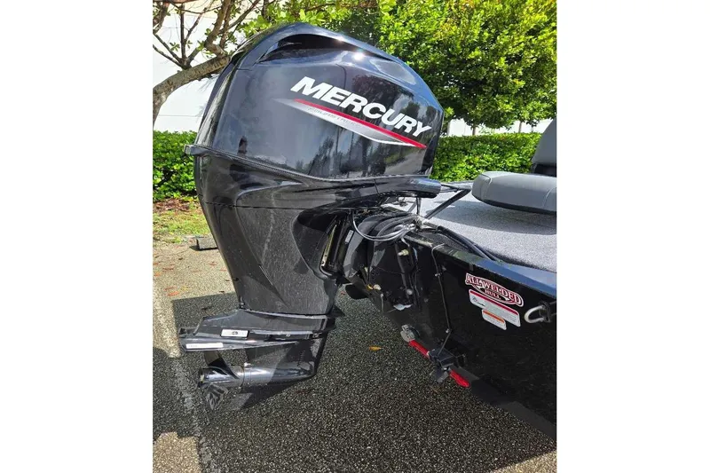 Slide: The Image of 2026 Tracker Bass Tracker Classic XL with Mercury outboard motor, parked outdoors. - 6