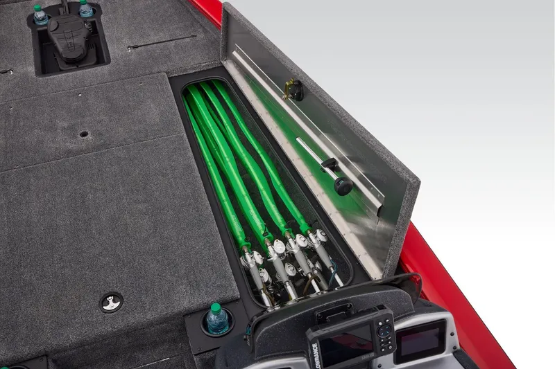 Slide: The Image of Open storage compartment on 2026 Tracker Pro Team 190 boat with gray carpet interior. - 19