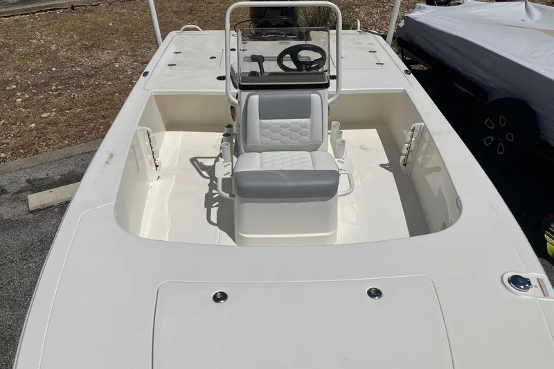 Slide: The Image of 2026 Mako 18 Pro Skiff boat interior with steering console and seating. - 8