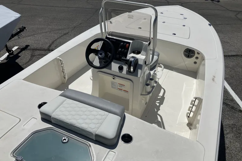 Slide: The Image of 2026 Mako 18 Pro Skiff boat interior with steering console and seating. - 7