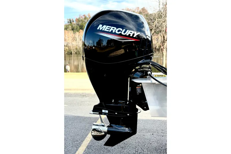 Slide: The Image of Mercury outboard motor on 2026 Sun Tracker Party Barge 22 RF DLX, near water. - 11