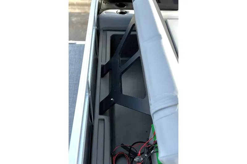 Slide: The Image of 2026 Sun Tracker Party Barge 22 RF DLX interior storage compartment with wiring. - 22