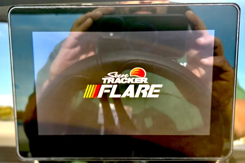 Slide: The Image of Display screen showing "Sun Tracker Flare" logo on a 2026 Party Barge 22 RF DLX. - 25