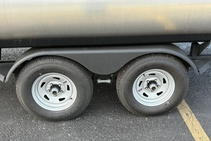 Slide: The Image of Trailer wheels of 2026 Sun Tracker Party Barge 22 RF DLX on asphalt. - 37