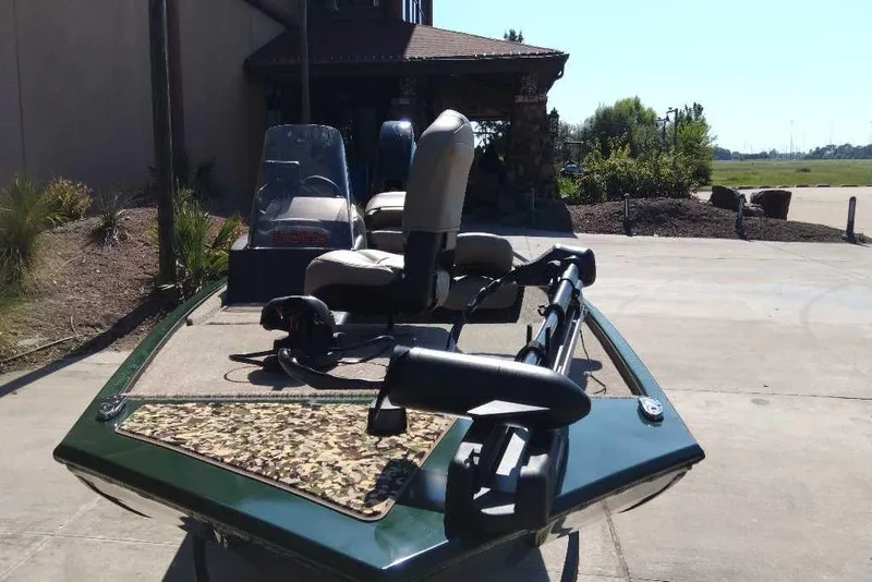 Slide: The Image of 2026 Tracker Bass Tracker Classic Limited boat parked outdoors. - 2