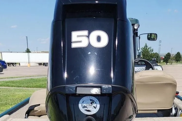 Slide: The Image of 2026 Tracker Bass Tracker Classic Limited boat engine with "50" marking, parked outdoors. - 13