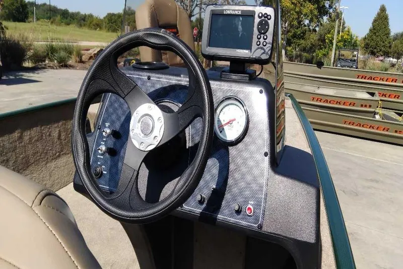 Slide: The Image of 2026 Tracker Bass Tracker Classic Limited dashboard with steering wheel and navigation system. - 4