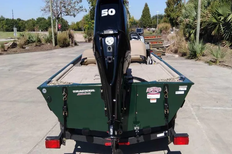 Slide: The Image of 2026 Tracker Bass Tracker Classic Limited boat with a 50 HP engine, parked outdoors. - 5