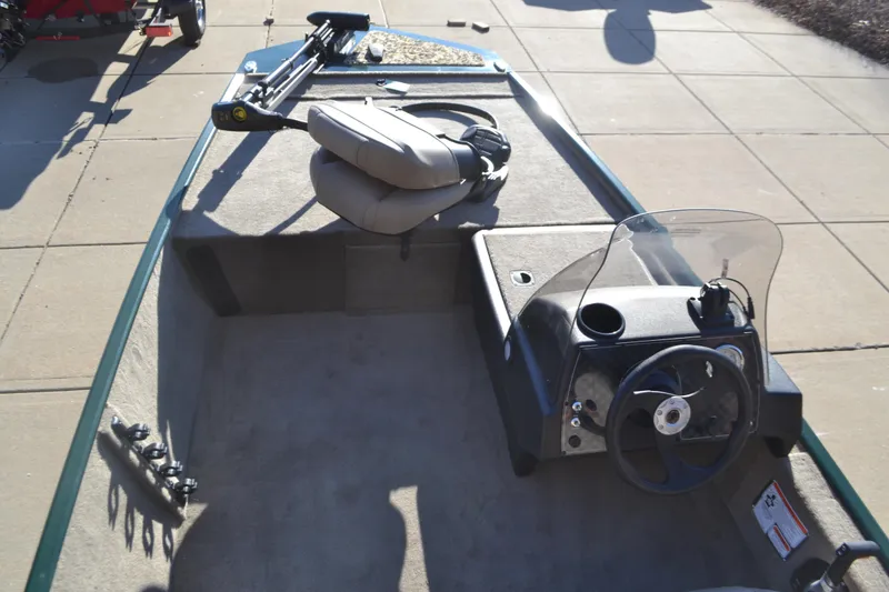 Slide: The Image of 2026 Tracker Bass Tracker Classic Limited boat interior with steering console and seating. - 7
