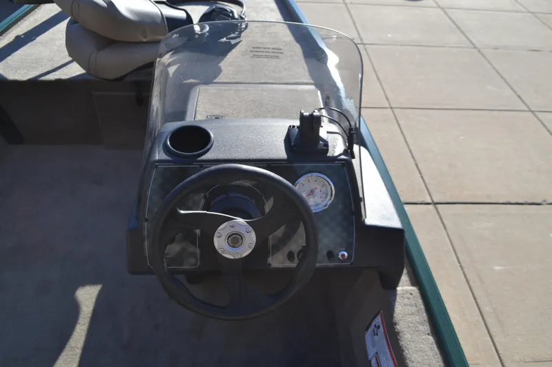 Slide: The Image of 2026 Tracker Bass Tracker Classic Limited boat dashboard with steering wheel and gauge. - 8