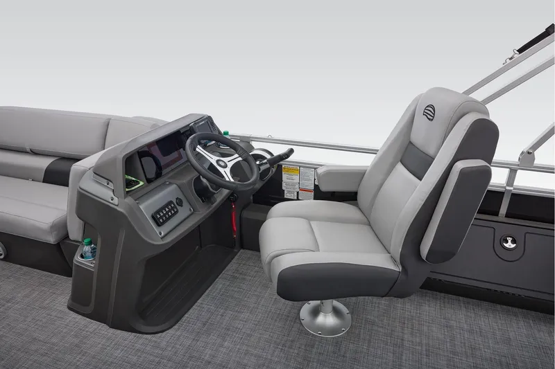 Slide: The Image of 2026 Sun Tracker SportFish 22 DLX pontoon boat interior with gray seating and steering console. - 30
