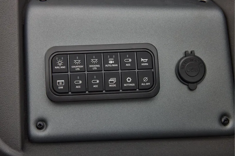 Slide: The Image of 2026 Sun Tracker SportFish 22 DLX boat dashboard with steering wheel and controls. - 34