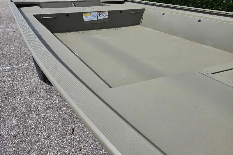 Slide: The Image of 2026 Tracker Grizzly 1754 Utility boat, spacious interior, parked on asphalt. - 3