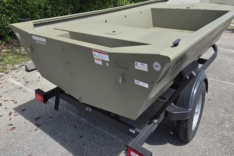 Slide: The Image of 2026 Tracker Grizzly 1754 Utility boat on trailer, parked outdoors. - 4