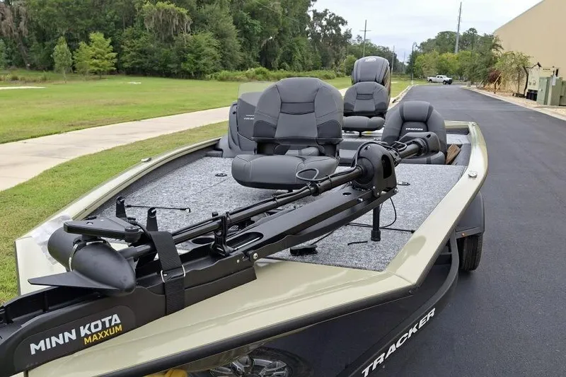 Slide: The Image of 2026 Tracker Pro Team 195 boat with Minn Kota Maxxum trolling motor on a paved road. - 3