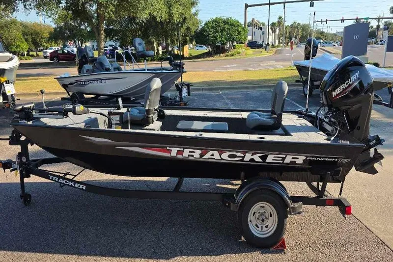 The Image of 2026 Tracker Panfish 17 boat on trailer, parked outdoors, featuring Mercury engine. - 0