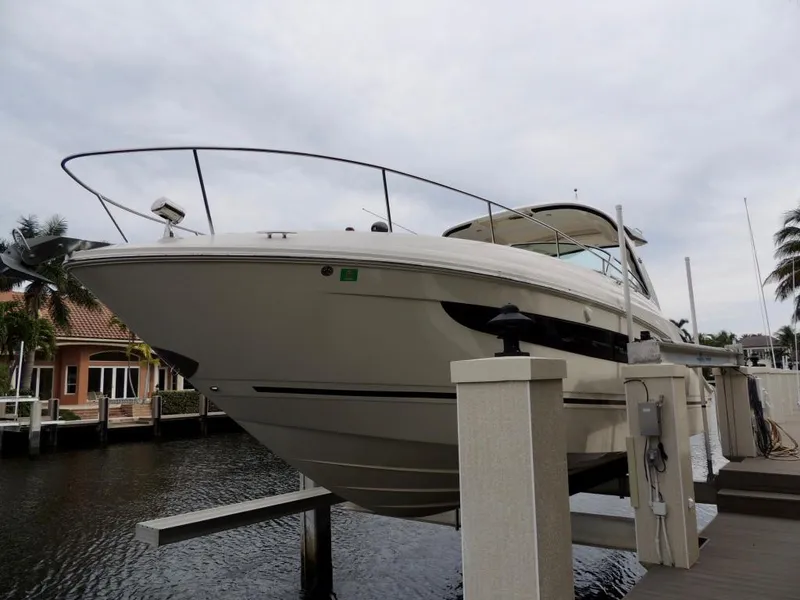 Slide: The Image of 2016 Sea Ray 350 Sundancer yacht docked, elevated above water, with clear blue sky. - 1