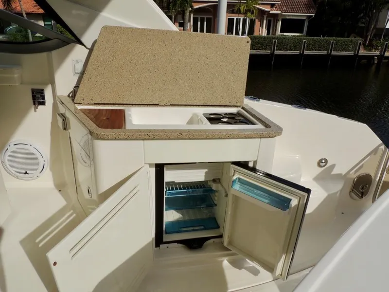 Slide: The Image of 2016 Sea Ray 350 Sundancer interior with beige seating and speaker. - 26