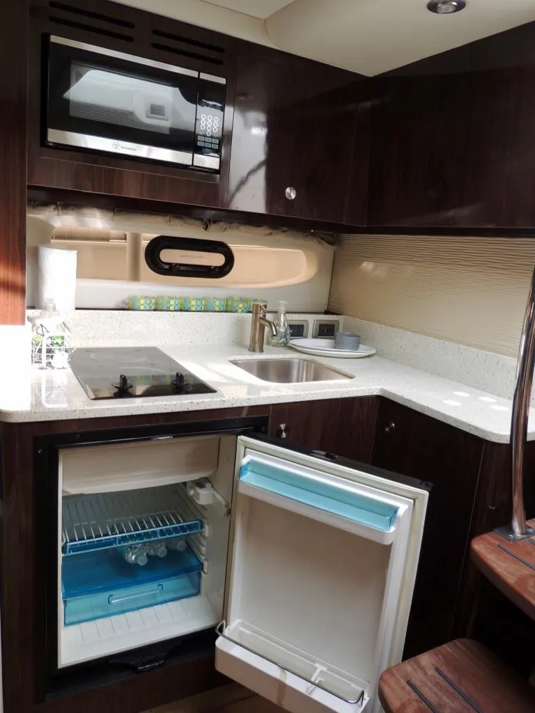 Slide: The Image of Luxurious 2016 Sea Ray 350 Sundancer yacht kitchen with modern amenities and sleek design. - 42