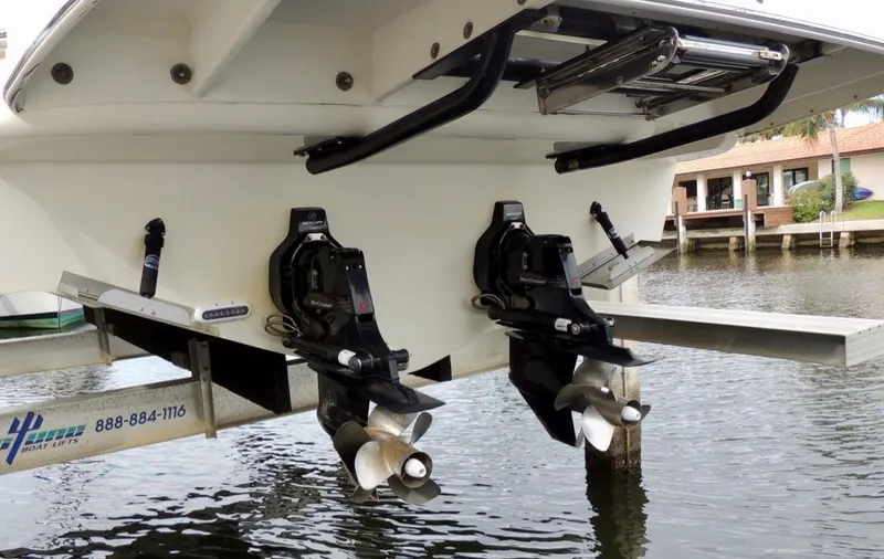 Slide: The Image of 2016 Sea Ray 350 Sundancer boat stern with dual propellers in marina. - 59