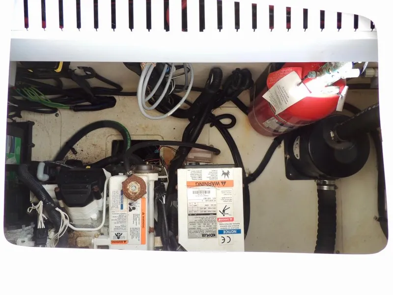 Slide: The Image of Engine compartment of a 2016 Sea Ray 350 Sundancer with fire extinguisher and wiring. - 64