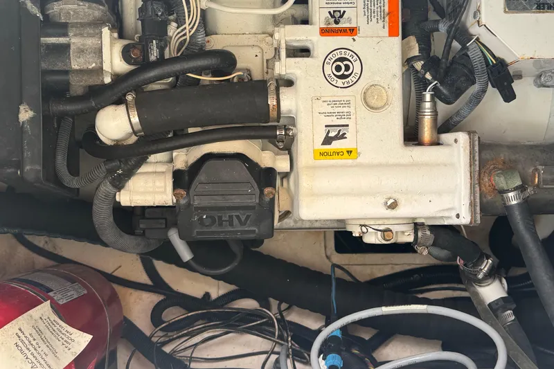 Slide: The Image of Engine compartment of a 2016 Sea Ray 350 Sundancer boat, showing mechanical components. - 70