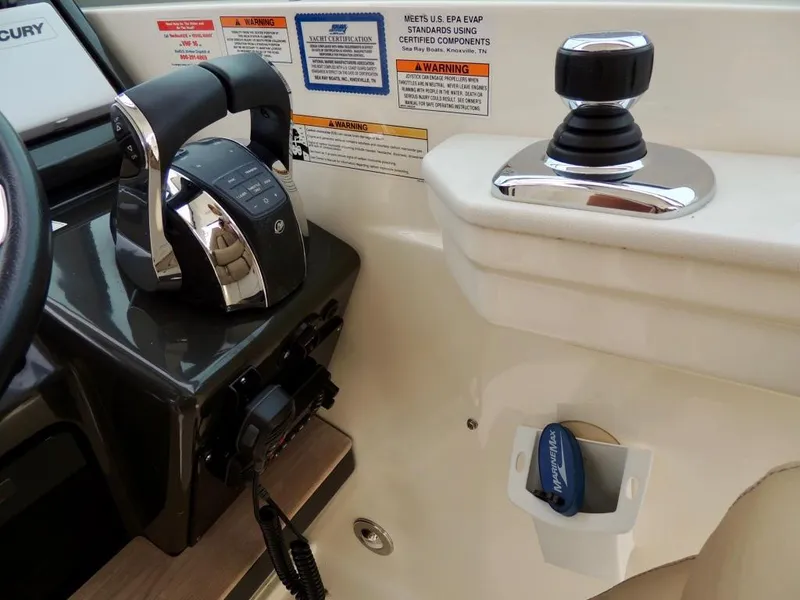 Slide: The Image of 2016 Sea Ray 350 Sundancer cockpit with helm, seating, and navigation controls. - 9