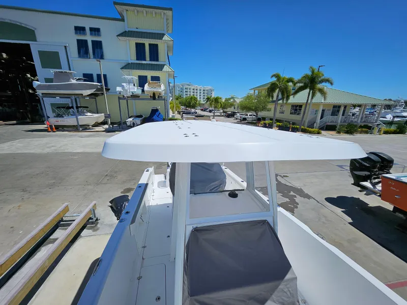 Slide: The Image of 2022 Century 2900 Center Console boat at marina, sunny day, palm trees in background. - 31