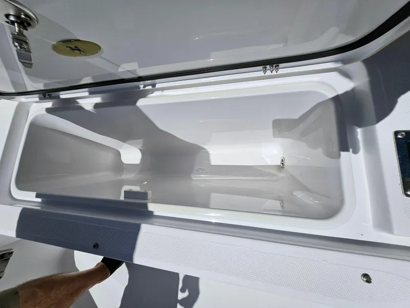 Slide: The Image of 2022 Century 2900 Center Console storage compartment, open and empty, with visible shadows. - 32