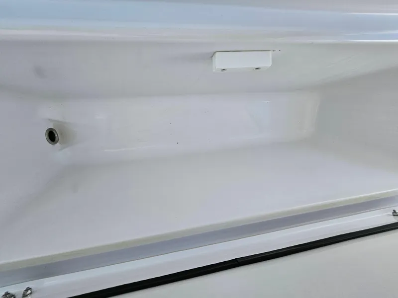 Slide: The Image of 2022 Century 2900 Center Console storage compartment, white interior, close-up view. - 36