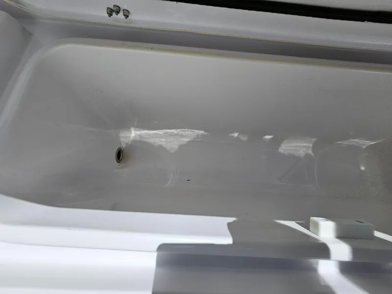 Slide: The Image of 2022 Century 2900 Center Console boat storage compartment, white interior, open lid. - 38
