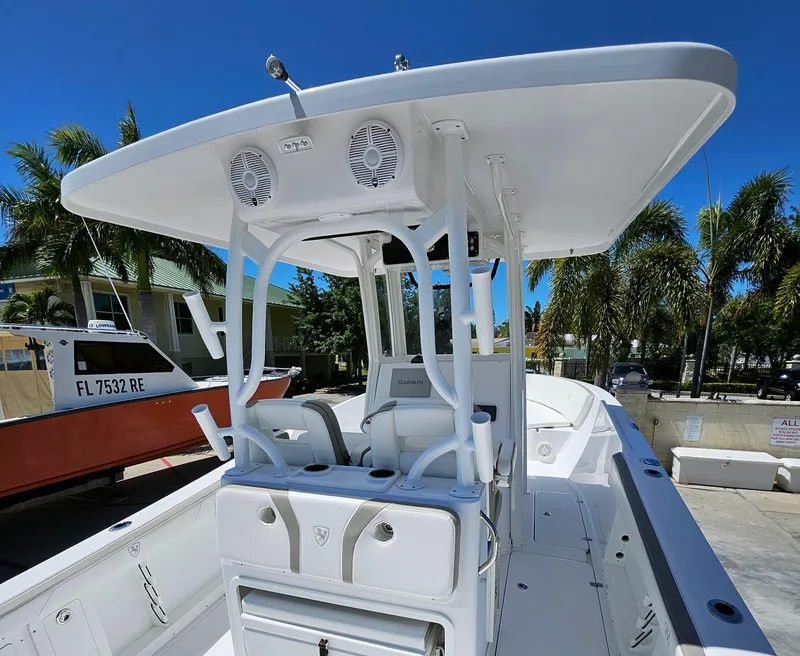 Slide: The Image of 2022 Century 2900 Center Console boat with T-top, docked under clear blue sky. - 47