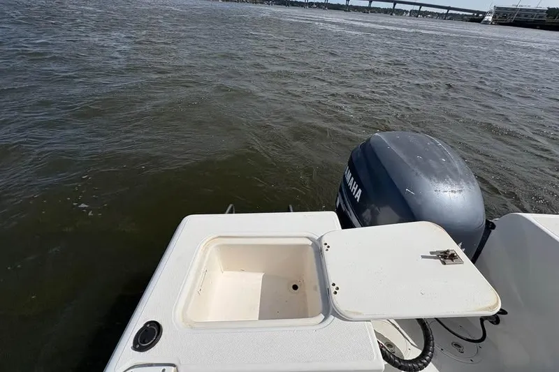 Slide: The Image of Edgewater 225CC boat with Yamaha engine on water, open storage compartment, 2001 model. - 10