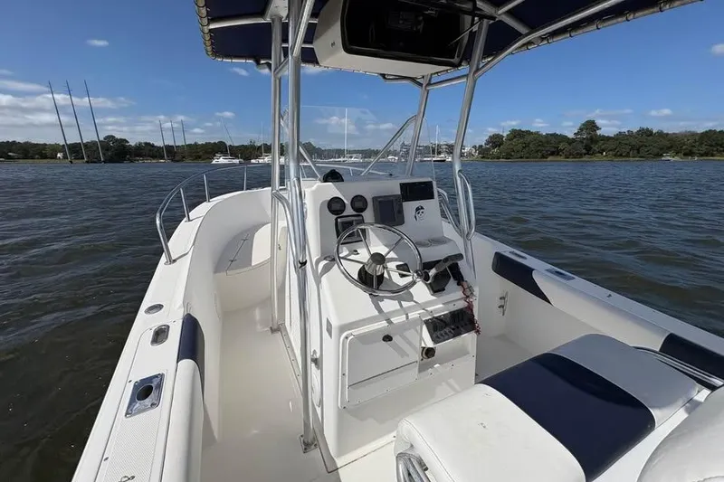 Slide: The Image of 2001 Edgewater 225CC boat interior with steering console on a sunny day. - 12