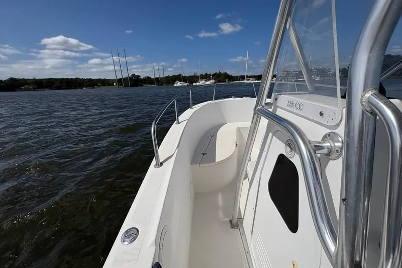 Slide: The Image of 2001 Edgewater 225CC boat on water, clear sky, and distant shoreline. - 15