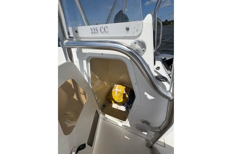 Slide: The Image of 2001 Edgewater 225CC boat storage compartment with safety equipment inside. - 16