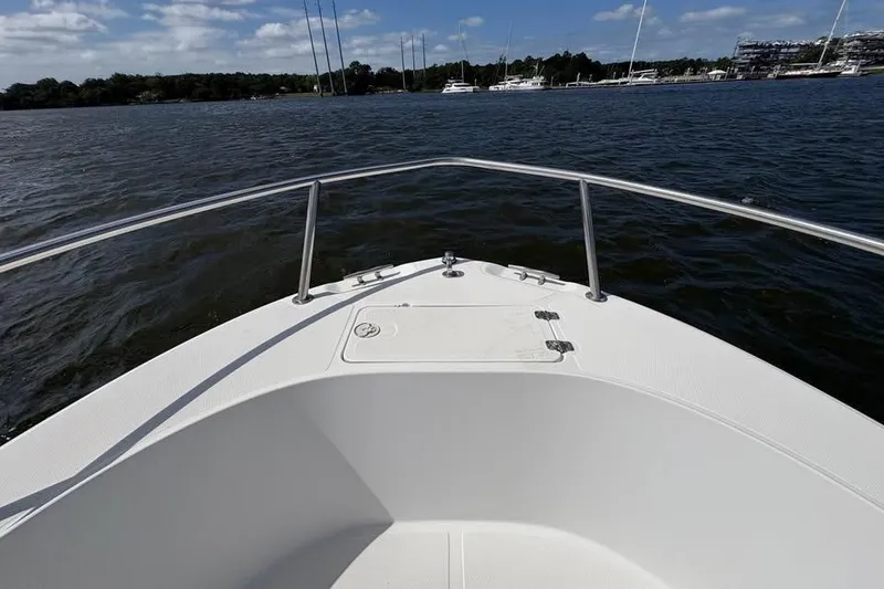 Slide: The Image of Bow view of 2001 Edgewater 225CC boat on calm water with clear sky. - 19
