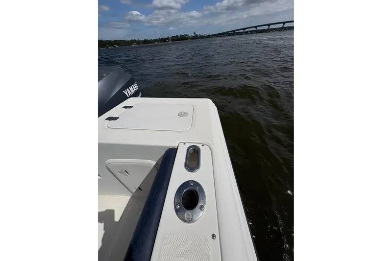 Slide: The Image of Edgewater 225CC boat deck with Yamaha engine, 2001 model, on a scenic waterway. - 9