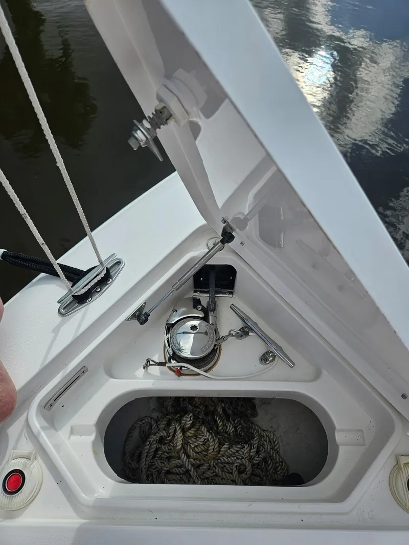 Slide: The Image of Open anchor compartment of 2005 Intrepid 323 Cuddy boat with ropes and hardware. - 19