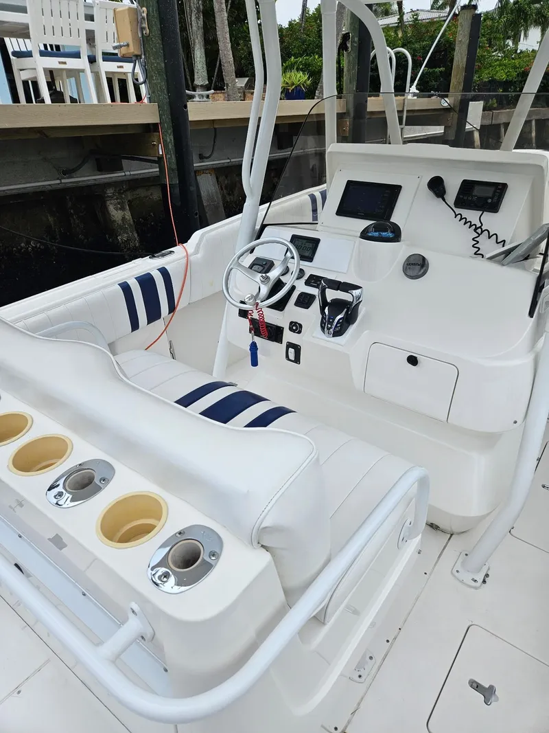 Slide: The Image of 2005 Intrepid 323 Cuddy boat cockpit with steering wheel and seating. - 5