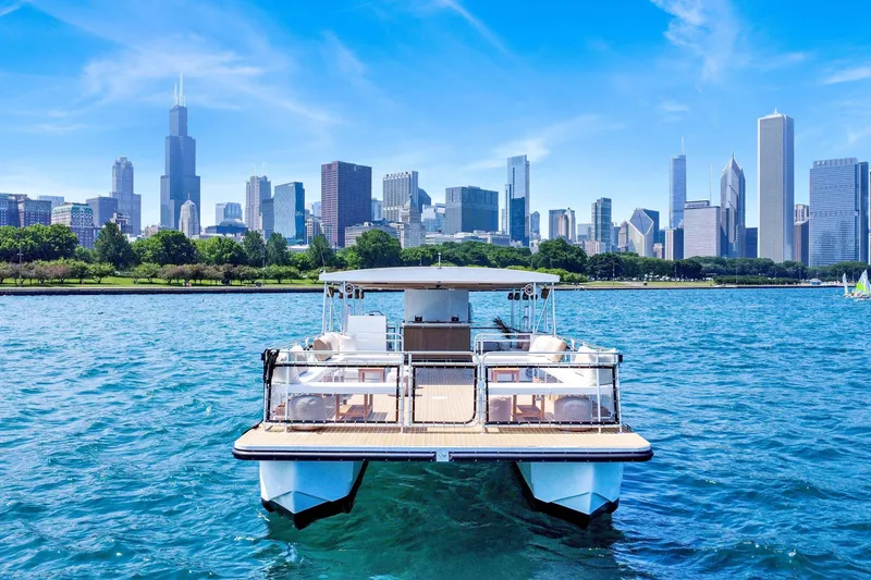 The Image of A&M Manufacturing COI 2026 boat on water with city skyline in background. - 0