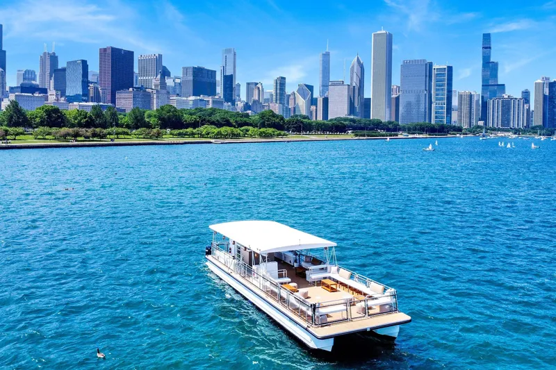 Slide: The Image of Modern A&M Manufacturing COI boat on blue water with city skyline, 2026 model. - 1