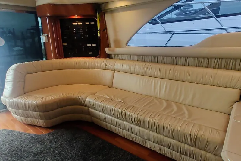 Slide: The Image of 2001 Sea Ray 560 Sedan Bridge yacht docked with American flag displayed. - 15